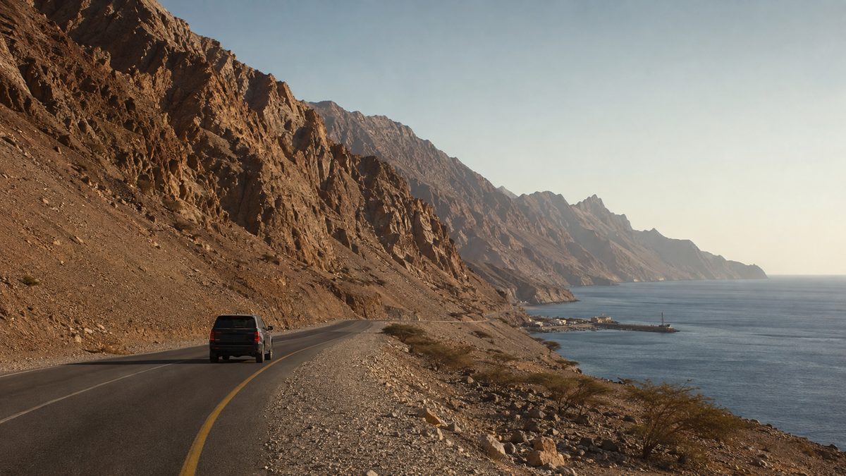 A coastal road on the UAE east coast, between the Hajar mountains and the Gulf of Oman